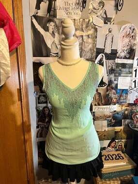 Maurice’s mint green V-neck tank top heavily embellished with rows of metallic s